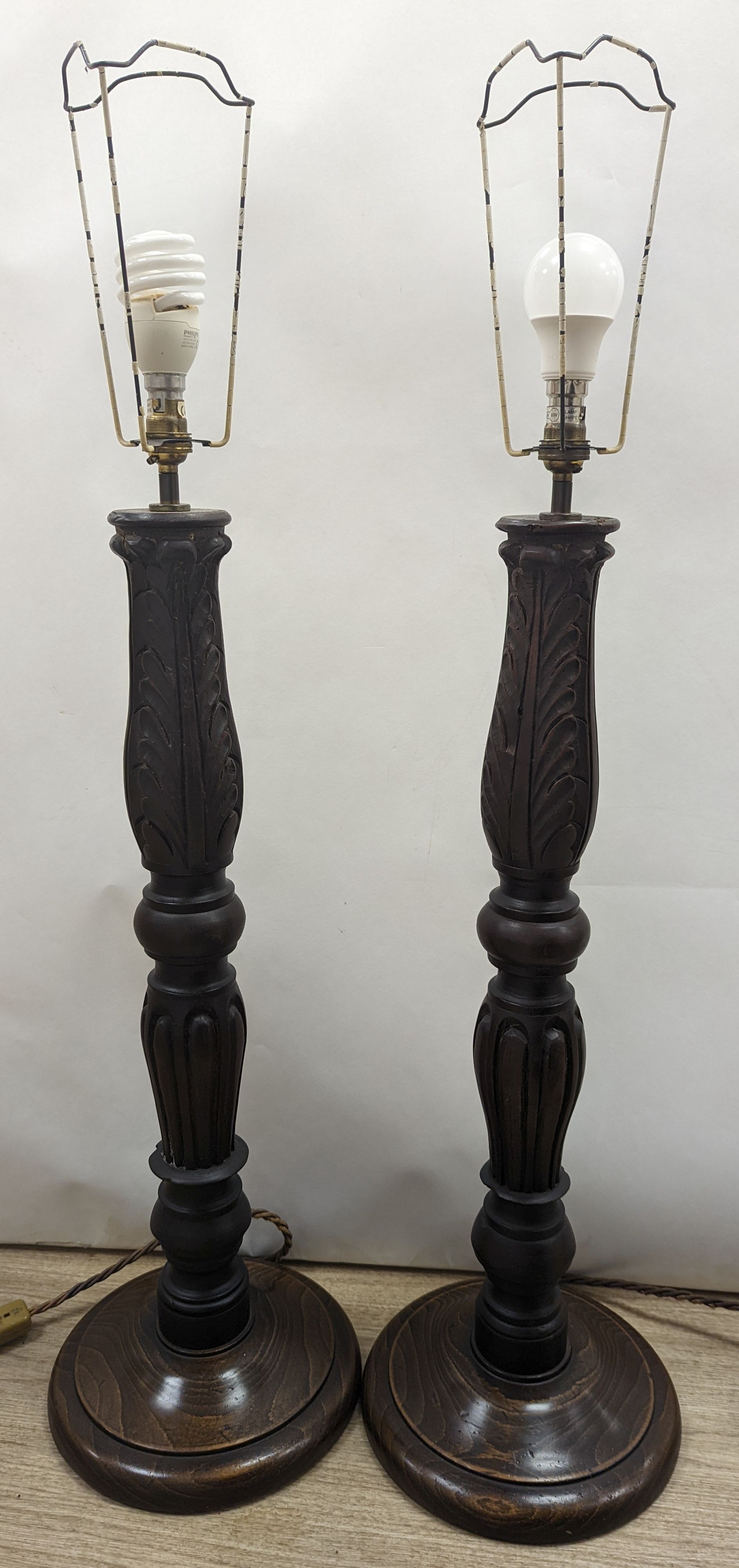 A pair of turned wood lamp bases, height 69cm excl. fitting